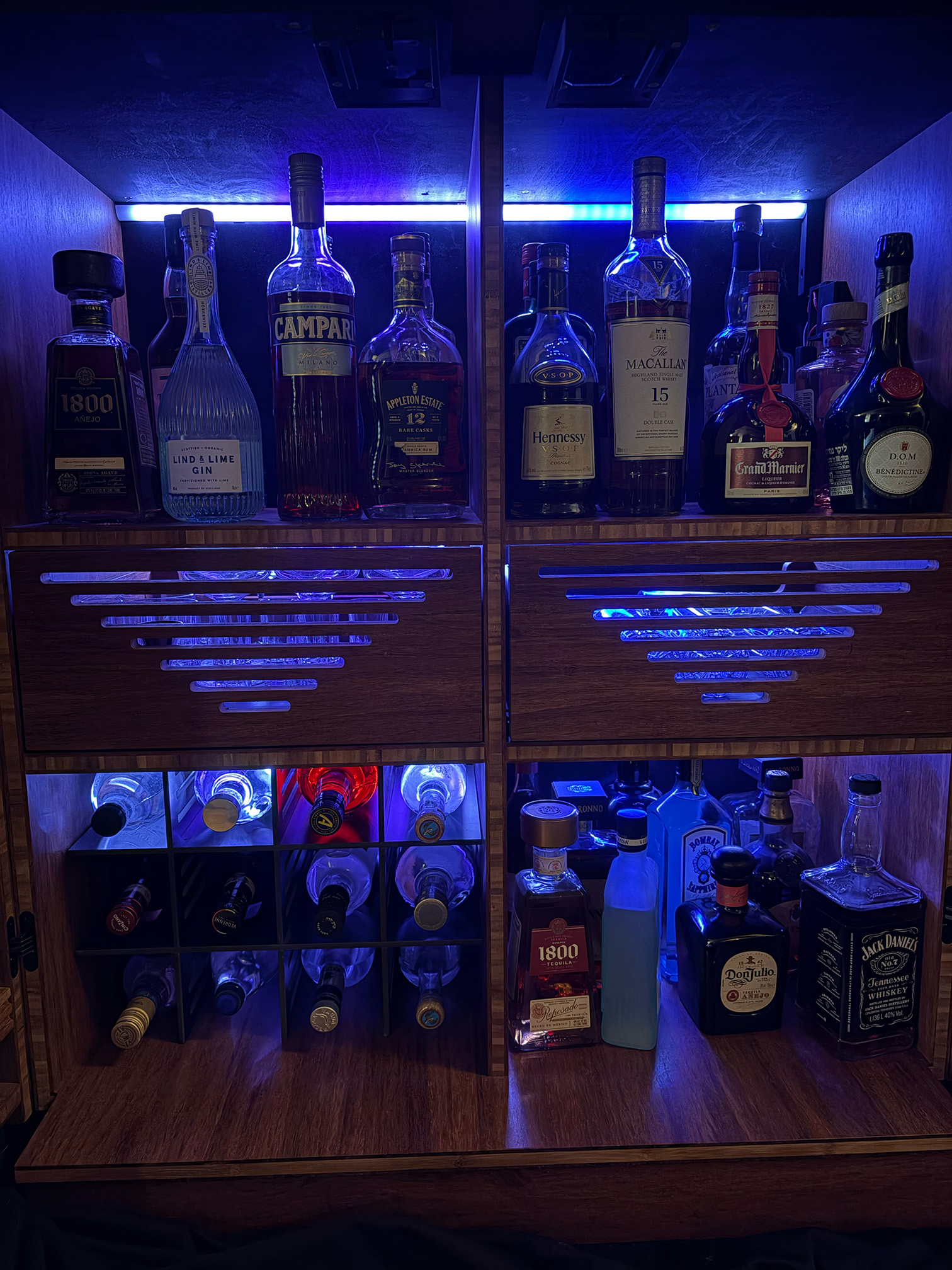 Open cabinet with full RGB LED bath across bottles and drawers